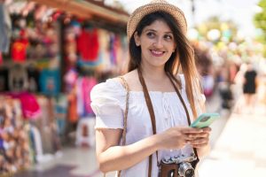 young-hispanic-woman-tourist-smiling-confident-using-smartphone-street-market (1) (1) (1)